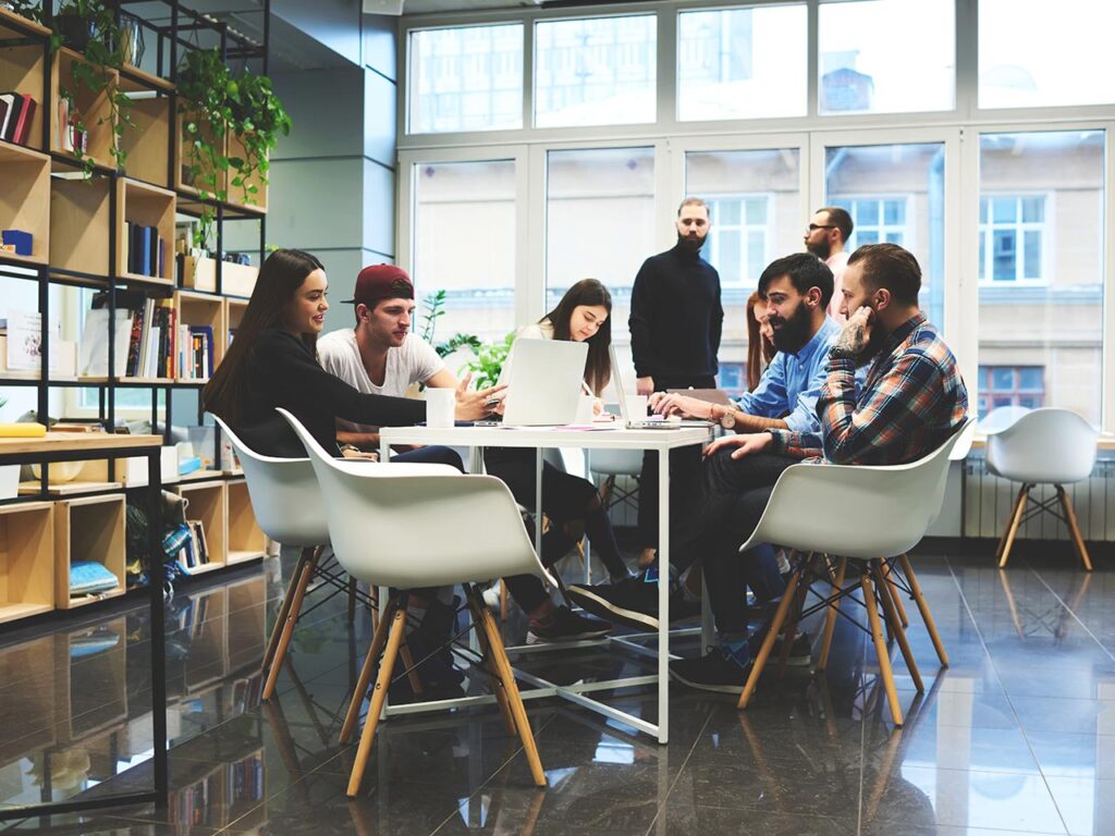 A group of creative people collaborating and having a meeting around the table in an office setting